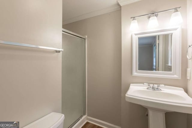 110 Valley View Ct, Tyrone, GA 30290 - bathroom with a sink, ornamental molding, toilet, and a shower stall