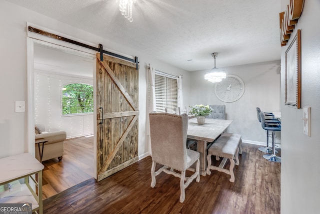 1029 Megan Ct, Sugar Hill, GA 30518 - dining area with a barn door, wood finished floors, baseboards, a textured ceiling, and a chandelier