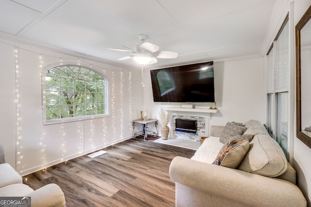 1029 Megan Ct, Sugar Hill, GA 30518 - living area with a fireplace, wood finished floors, ceiling fan, and ornamental molding
