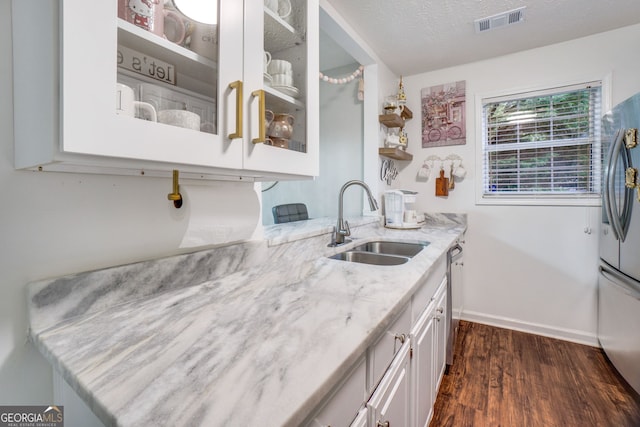 1029 Megan Ct, Sugar Hill, GA 30518 - kitchen with a sink, stainless steel fridge, dark wood-type flooring, light stone counters, and baseboards