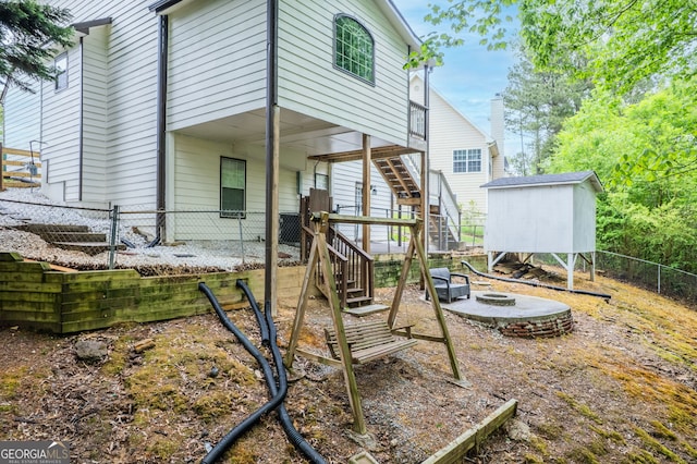 1029 Megan Ct, Sugar Hill, GA 30518 - rear view of house with stairs, a fenced backyard, an outdoor fire pit, and an outbuilding