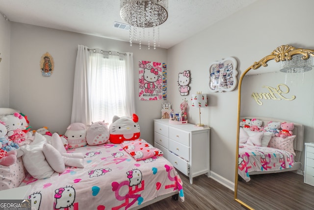 1029 Megan Ct, Sugar Hill, GA 30518 - bedroom with dark wood-type flooring, baseboards, and a chandelier