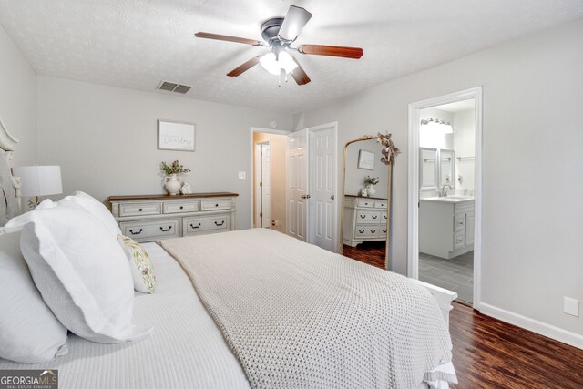 1029 Megan Ct, Sugar Hill, GA 30518 - bedroom featuring a sink, wood finished floors, baseboards, a ceiling fan, and ensuite bathroom