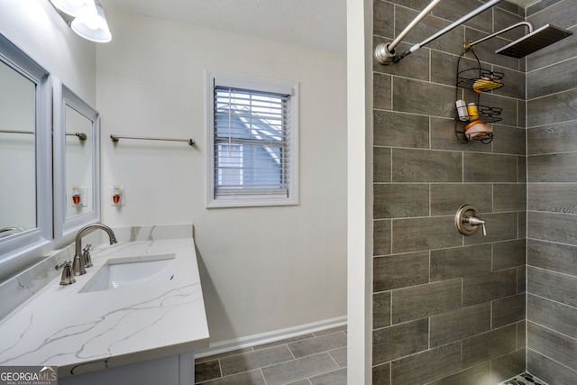 1029 Megan Ct, Sugar Hill, GA 30518 - full bathroom with a tile shower, vanity, and baseboards