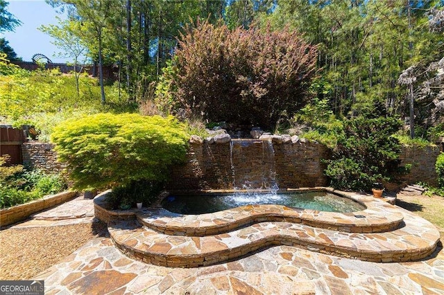 view of swimming pool featuring fence