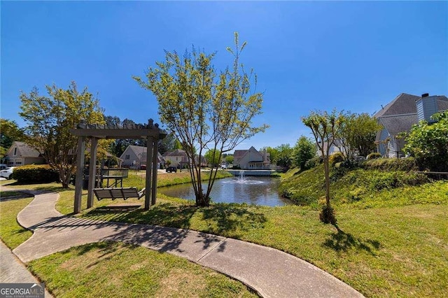 view of property's community with a yard, a water view, and a residential view