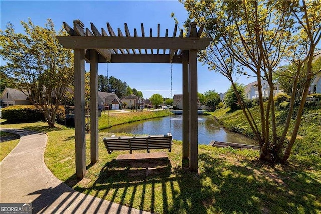 view of home's community featuring a lawn, a water view, and a pergola