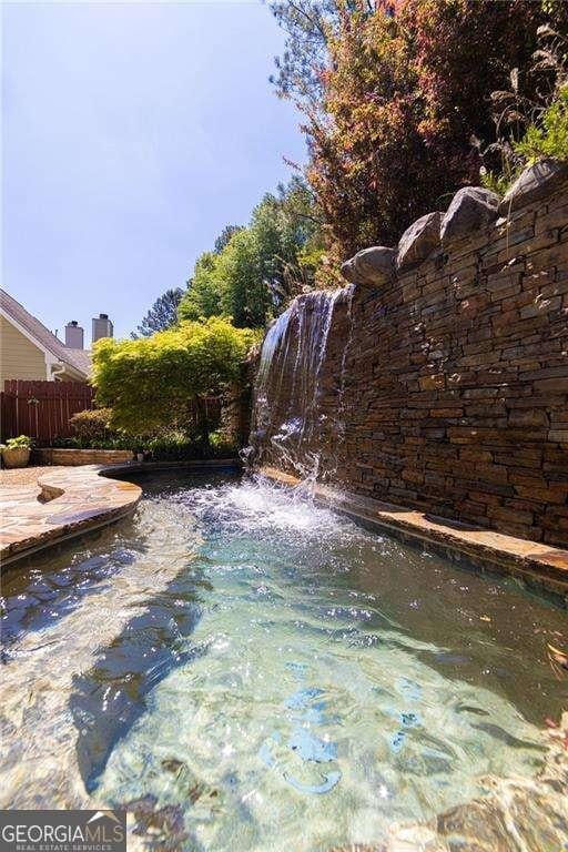 view of yard featuring fence and a fenced in pool