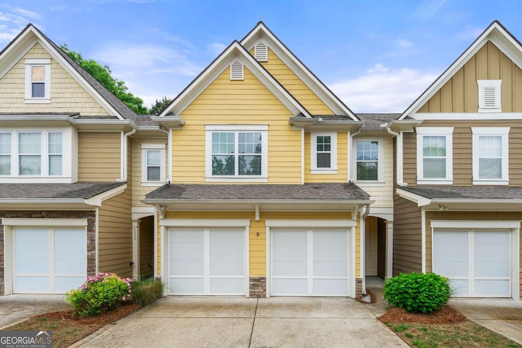 2060 Ellison Way NW Unit 11, Kennesaw, GA 30152 - view of property featuring an attached garage, driveway, and roof with shingles