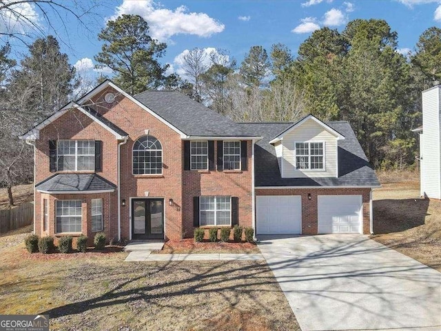 5854 Cobalt Dr, Powder Springs, GA 30127 - colonial home featuring concrete driveway, an attached garage, fence, french doors, and brick siding