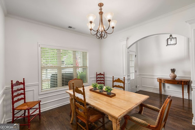 dining area featuring a chandelier, arched walkways, crown molding, and dark wood finished floors