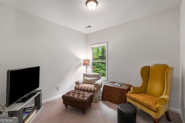sitting room featuring visible vents, baseboards, and carpet floors