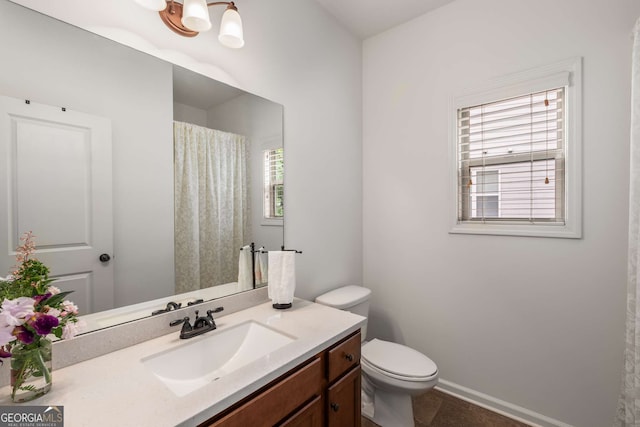 bathroom featuring tile patterned flooring, a shower with curtain, toilet, vanity, and baseboards