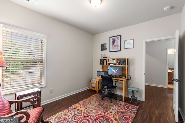 office space with wood finished floors, visible vents, and baseboards