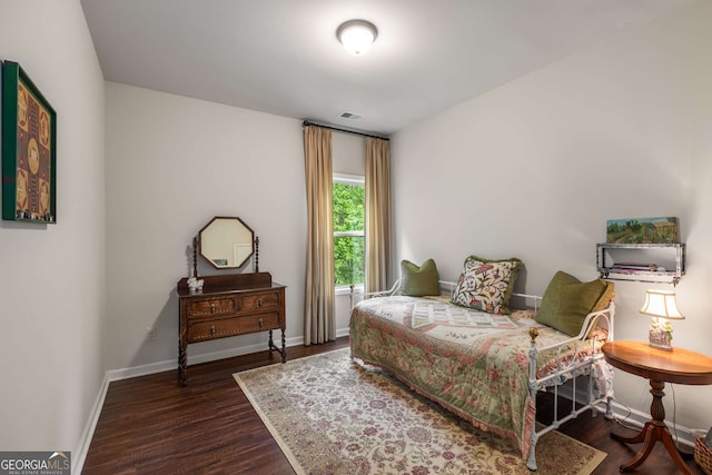 bedroom featuring visible vents, wood finished floors, and baseboards