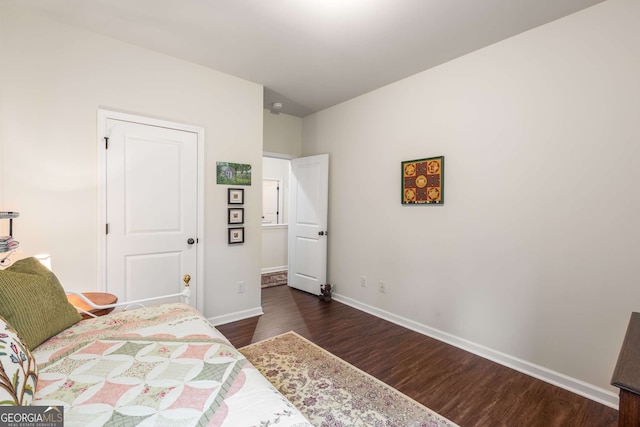 bedroom with wood finished floors and baseboards