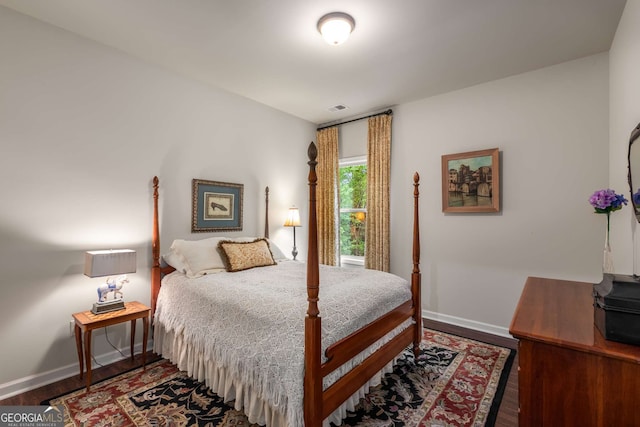 bedroom with wood finished floors and baseboards