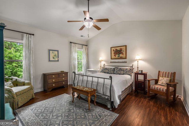 bedroom with multiple windows, vaulted ceiling, wood finished floors, and visible vents