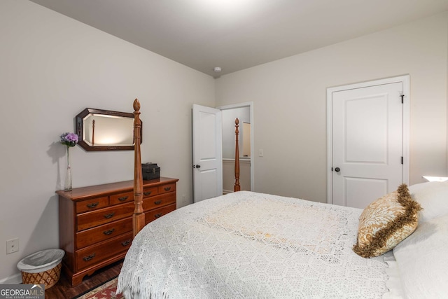 bedroom with wood finished floors and baseboards
