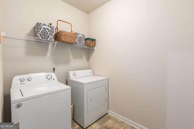 laundry room featuring baseboards, laundry area, and washing machine and dryer