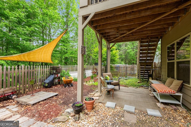 view of patio featuring stairway and a fenced backyard