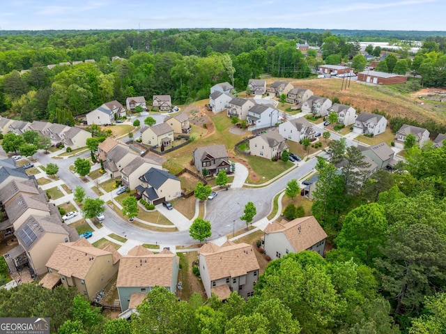 birds eye view of property with a residential view and a wooded view