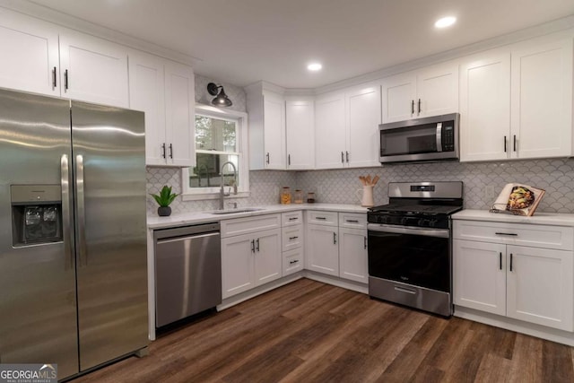 607 Hickory Creek Ln, Woodstock, GA 30188 - kitchen with stainless steel appliances, a sink, light countertops, dark wood-style flooring, and white cabinets