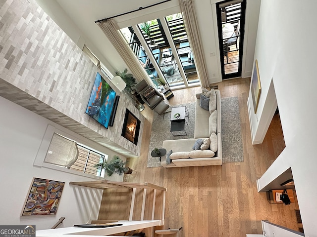 300 Mado Ln, Chattahoochee Hills, GA 30268 - living room with a high ceiling, wood finished floors, and baseboards