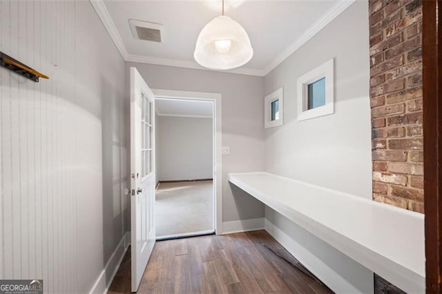 mudroom with wood finished floors, crown molding, visible vents, and baseboards