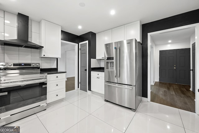2302 Aurie Dr, Decatur, GA 30034 - kitchen with appliances with stainless steel finishes, wall chimney range hood, white cabinetry, dark countertops, and recessed lighting