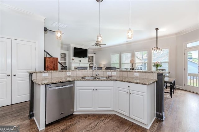 kitchen featuring stainless steel dishwasher, dark wood-style flooring, a sink, a ceiling fan, and crown molding
