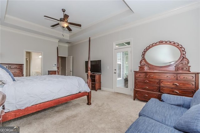 bedroom with ceiling fan, carpet flooring, ensuite bathroom, a raised ceiling, and crown molding
