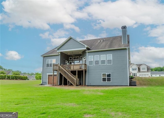 back of house featuring a chimney, stairway, a wooden deck, and a yard