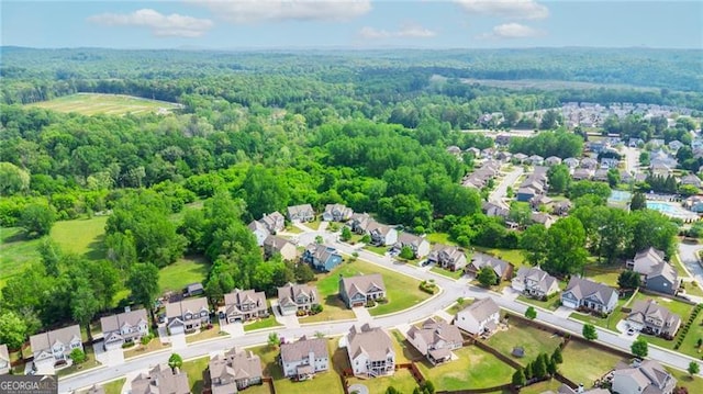 drone / aerial view with a view of trees and a residential view