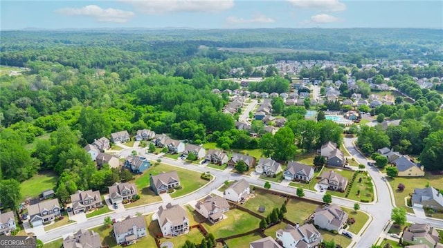 drone / aerial view with a view of trees and a residential view