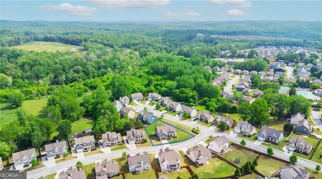 birds eye view of property with a wooded view and a residential view