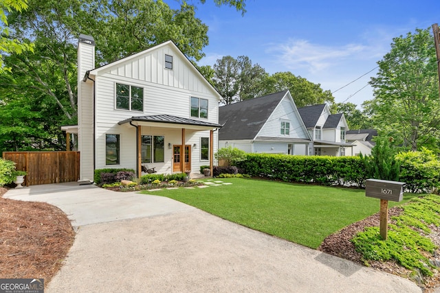 1671 Laurel Ave NW, Atlanta, GA 30318 - modern farmhouse featuring board and batten siding, a standing seam roof, a chimney, a front yard, and fence
