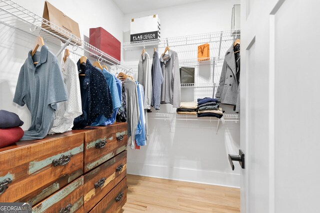 1671 Laurel Ave NW, Atlanta, GA 30318 - walk in closet featuring wood finished floors