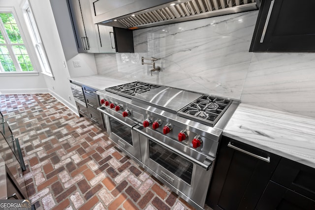 139 Thornhill Cir, Athens, GA 30607 - kitchen featuring light stone counters, range with two ovens, baseboards, decorative backsplash, and custom exhaust hood