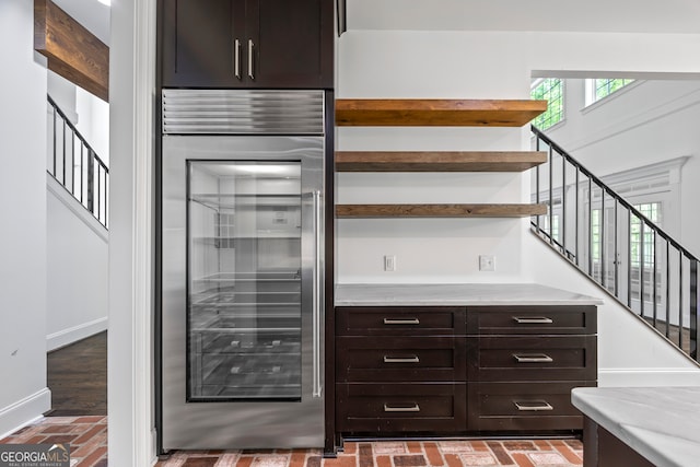 139 Thornhill Cir, Athens, GA 30607 - bar with baseboards, brick floor, stainless steel built in fridge, and stairway