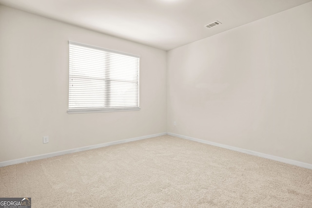 15 Manas Ct, Covington, GA 30016 - carpeted spare room with visible vents and baseboards