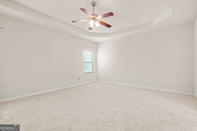 15 Manas Ct, Covington, GA 30016 - unfurnished room featuring ceiling fan, baseboards, light colored carpet, and a tray ceiling