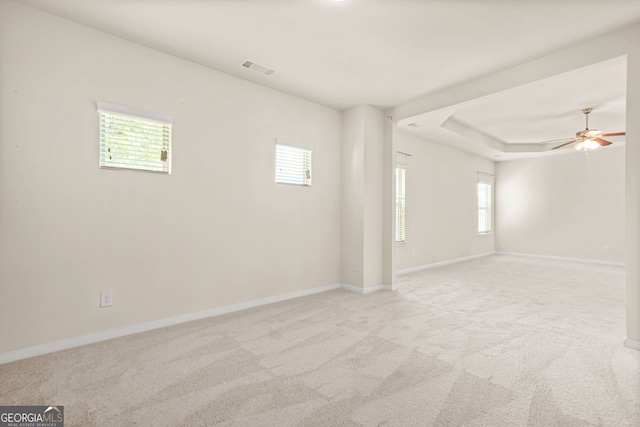 15 Manas Ct, Covington, GA 30016 - empty room with baseboards, a ceiling fan, a healthy amount of sunlight, and light colored carpet