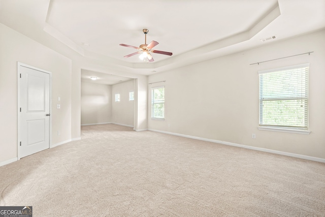 15 Manas Ct, Covington, GA 30016 - empty room with light colored carpet, a raised ceiling, a ceiling fan, and visible vents