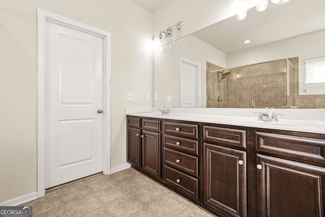 15 Manas Ct, Covington, GA 30016 - bathroom featuring double vanity, baseboards, a stall shower, and a sink