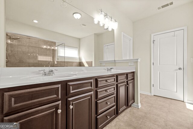 15 Manas Ct, Covington, GA 30016 - bathroom with tile patterned floors, double vanity, a sink, baseboards, and visible vents