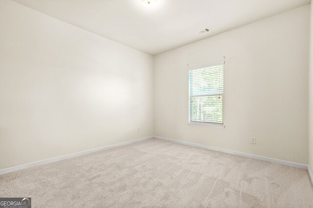 15 Manas Ct, Covington, GA 30016 - empty room featuring light colored carpet, visible vents, and baseboards