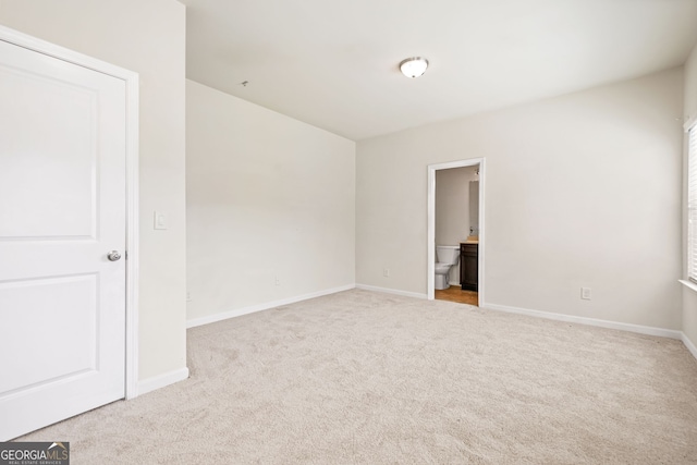 15 Manas Ct, Covington, GA 30016 - unfurnished bedroom featuring connected bathroom, carpet floors, and baseboards