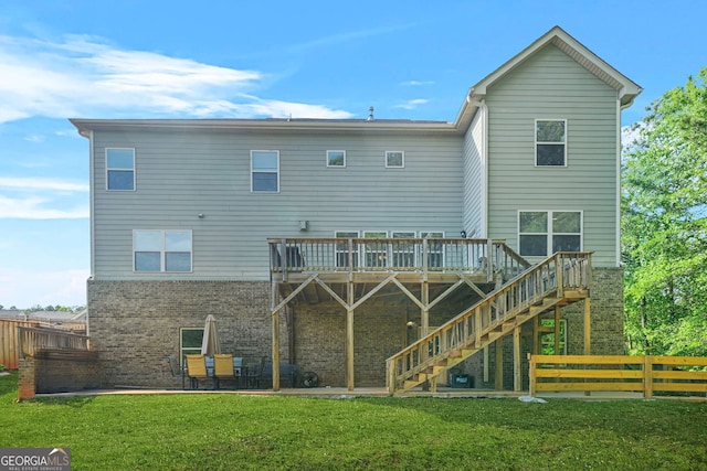 15 Manas Ct, Covington, GA 30016 - rear view of house featuring a yard, stairs, brick siding, a deck, and fence