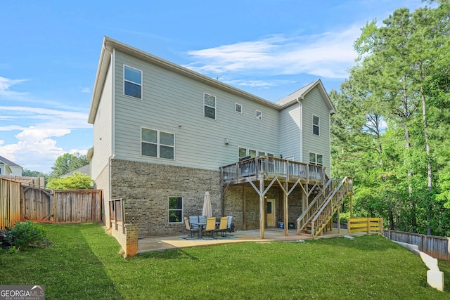 15 Manas Ct, Covington, GA 30016 - rear view of property with a patio, brick siding, a wooden deck, and a lawn